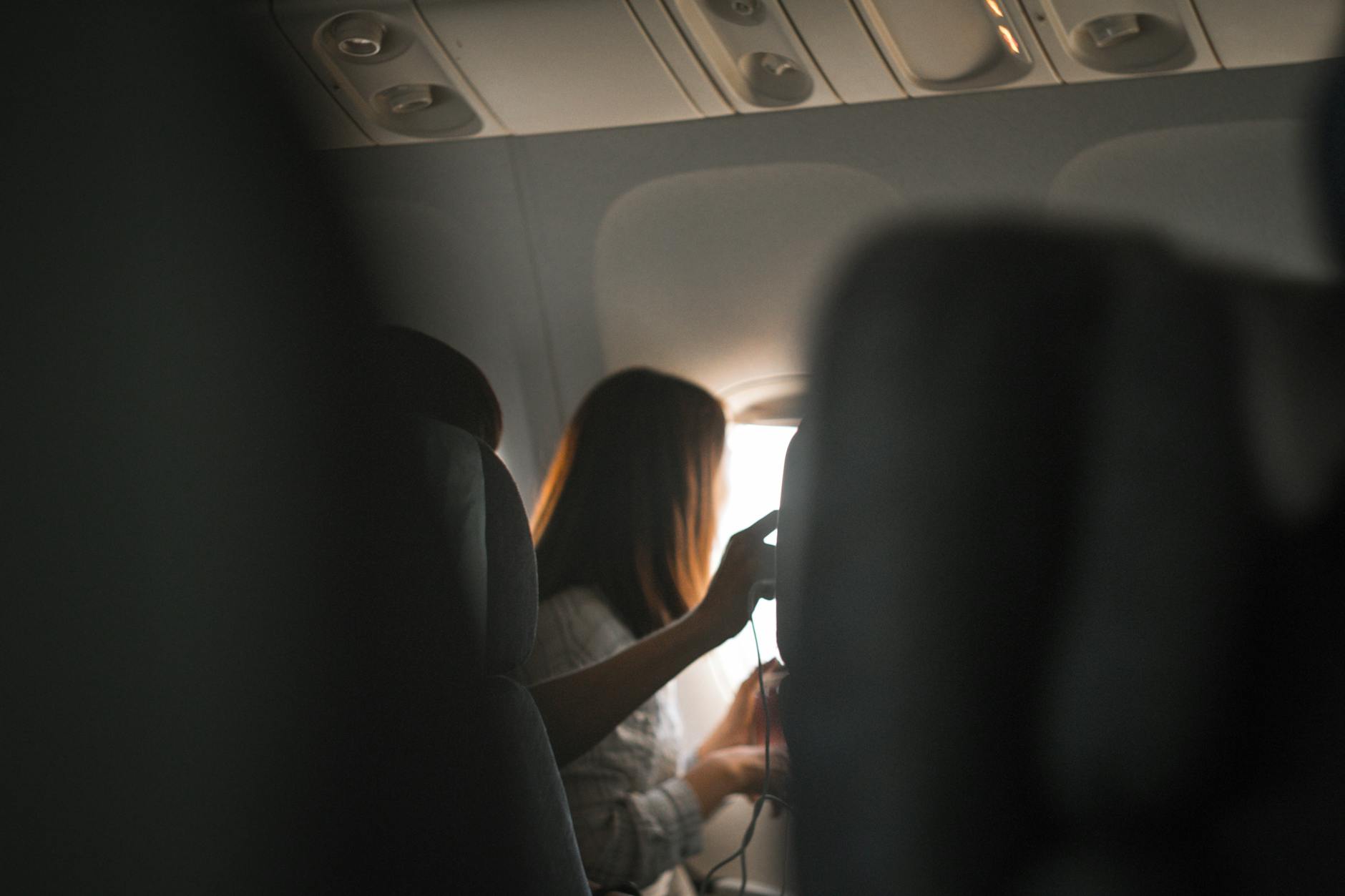 woman riding in airplane near window